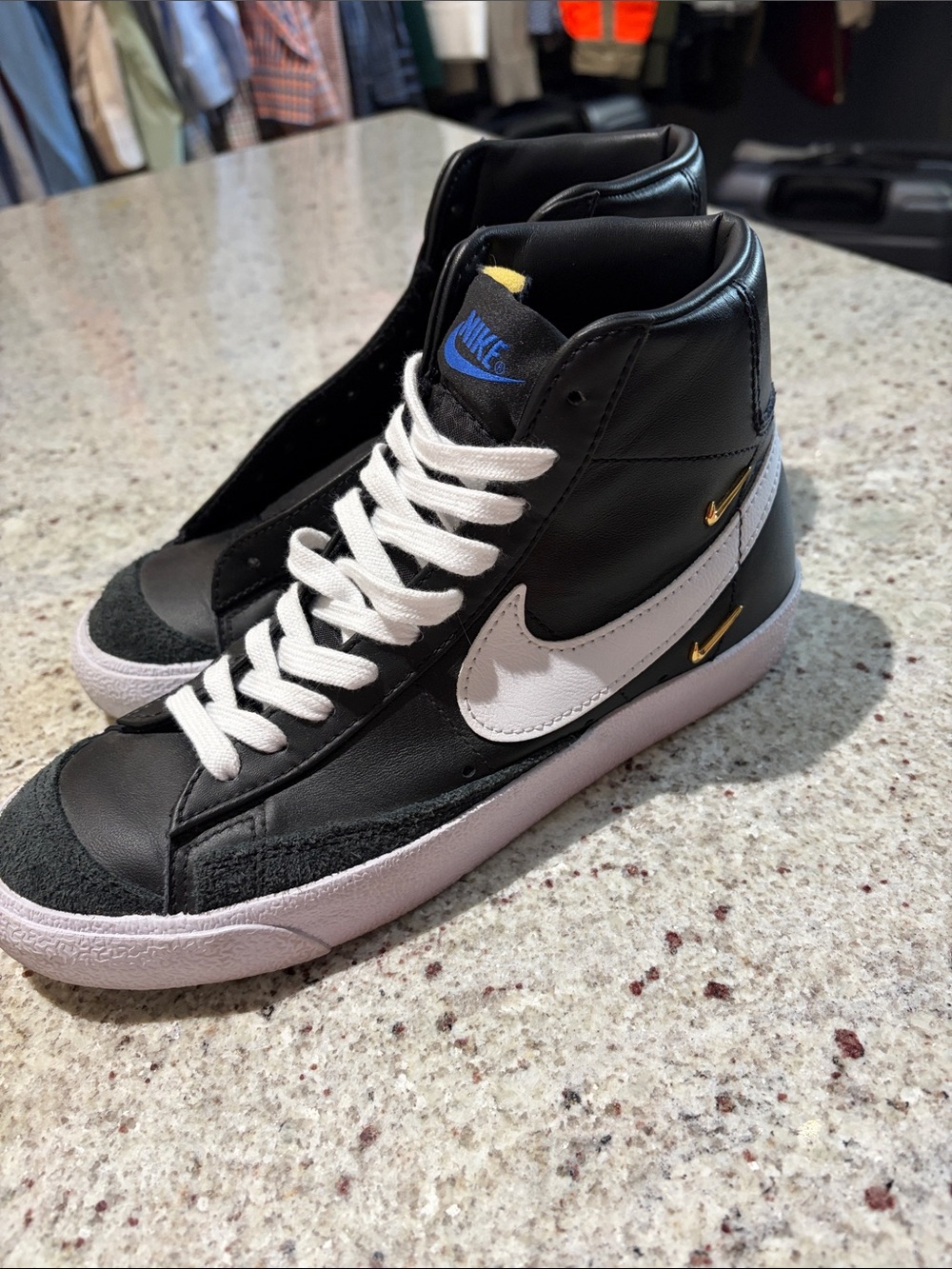 Nike Black and White High-Top Sneaker with Gold Accents
